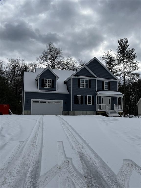 view of front property featuring a garage and covered porch