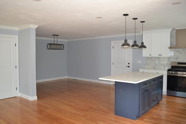 28 Barrows St, Norton, MA 02766 - kitchen featuring stainless steel range with gas stovetop, white cabinetry, light countertops, tasteful backsplash, and light wood-style flooring