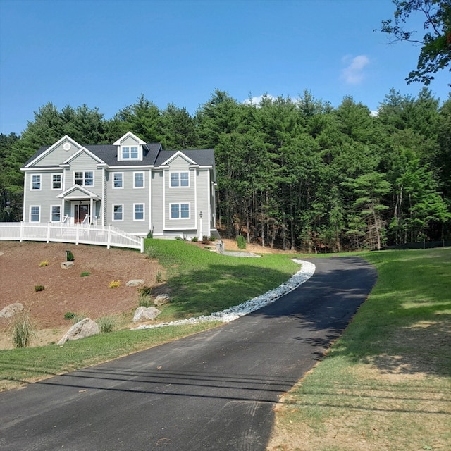 view of front of house with covered porch and a front yard