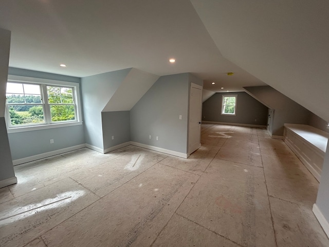 additional living space with a healthy amount of sunlight and vaulted ceiling