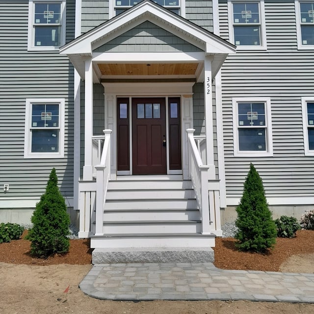 view of exterior entry with a porch