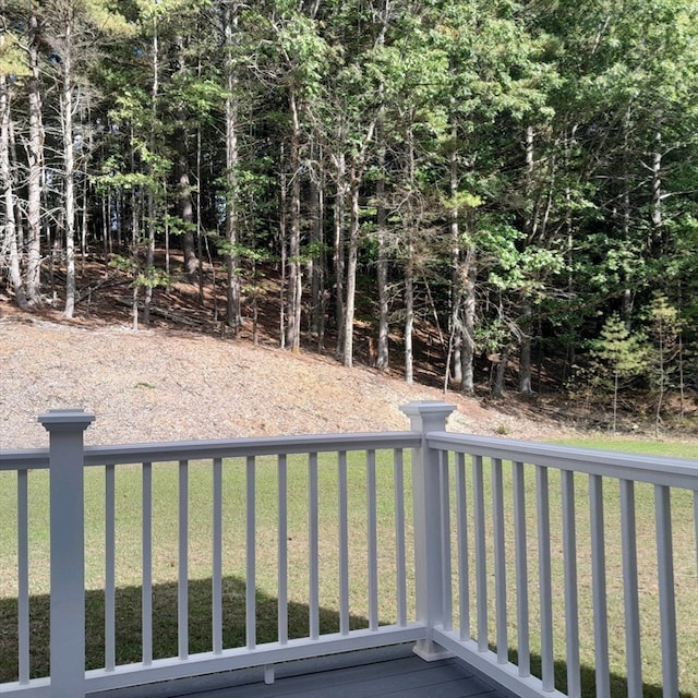 wooden terrace featuring a lawn