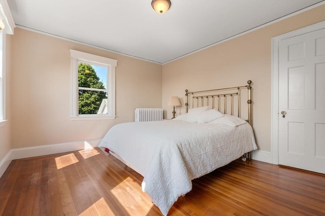 22 Adams Ave, Watertown, MA 02472 - bedroom featuring radiator heating unit, baseboards, and wood finished floors