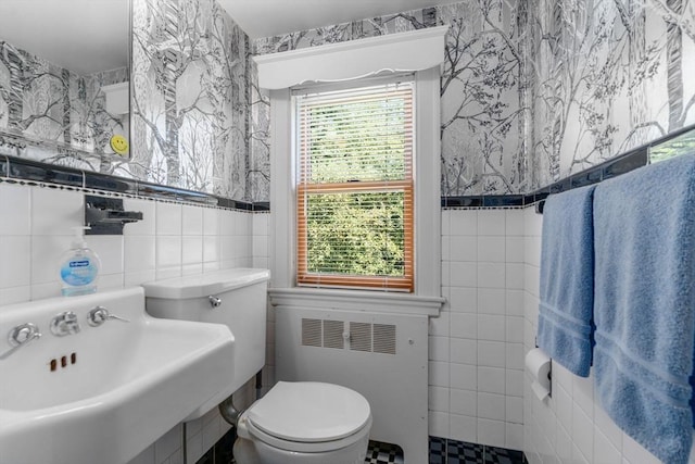 22 Adams Ave, Watertown, MA 02472 - bathroom with tile walls, toilet, radiator heating unit, and a sink