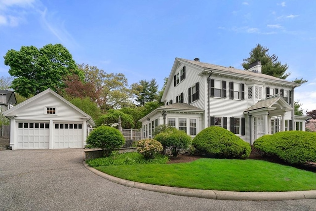 22 Adams Ave, Watertown, MA 02472 - view of front of property featuring a front lawn, a chimney, and a garage