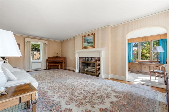 22 Adams Ave, Watertown, MA 02472 - living area featuring a wealth of natural light, a glass covered fireplace, wallpapered walls, and baseboards