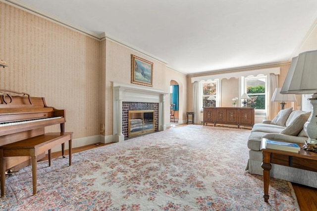 22 Adams Ave, Watertown, MA 02472 - living area featuring a tiled fireplace, wallpapered walls, baseboards, and ornamental molding