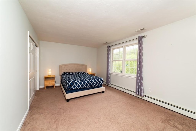 bedroom featuring a baseboard radiator, carpet flooring, and baseboards