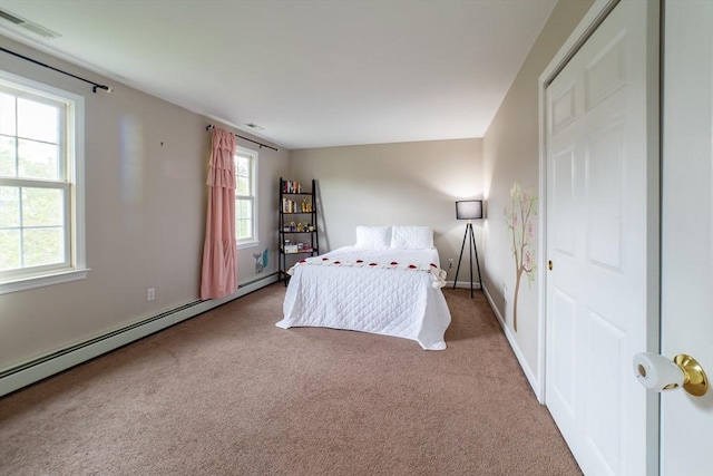 bedroom with carpet flooring, a baseboard radiator, and baseboards