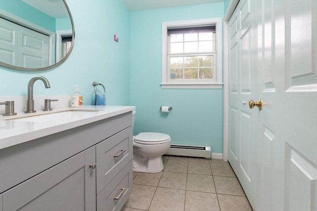 bathroom with baseboard heating, toilet, tile patterned floors, vanity, and baseboards