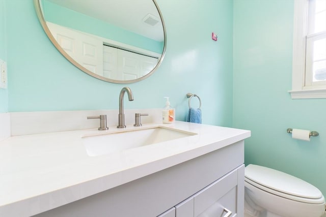 bathroom featuring toilet and vanity