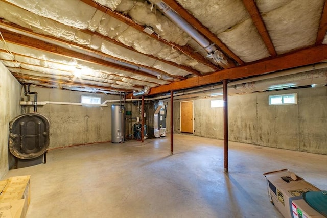 below grade area with gas water heater, oil tank, and heating unit