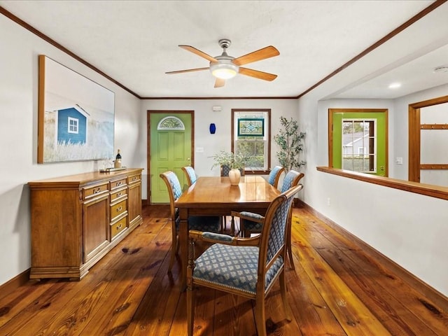 dining area with dark hardwood / wood-style flooring, ceiling fan, and crown molding