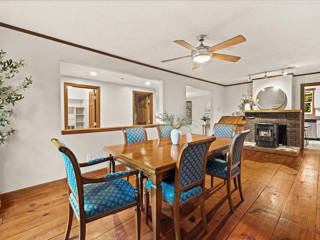 dining room with ceiling fan, crown molding, and hardwood / wood-style flooring