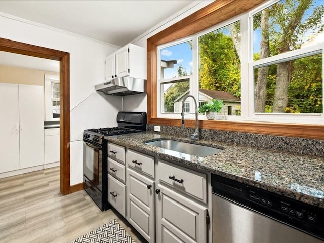 kitchen featuring sink, white cabinetry, dishwasher, dark stone countertops, and black gas stove