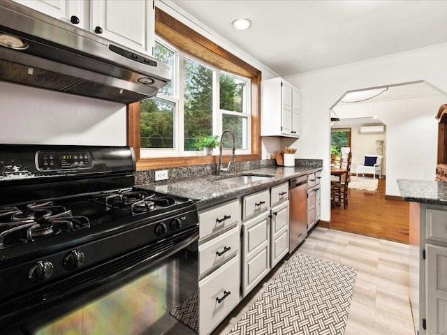 kitchen featuring black gas range, sink, white cabinetry, stainless steel dishwasher, and range hood