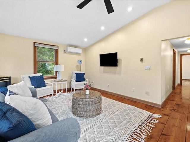 living room with ceiling fan, an AC wall unit, hardwood / wood-style floors, and vaulted ceiling