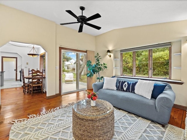 living room featuring ceiling fan, plenty of natural light, and wood-type flooring