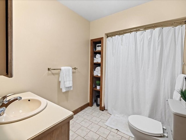 bathroom with tile patterned floors, vanity, and toilet