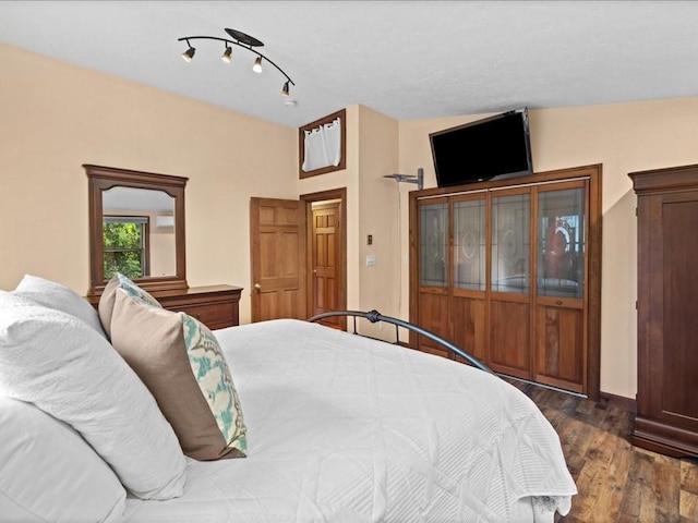 bedroom with dark hardwood / wood-style flooring and vaulted ceiling