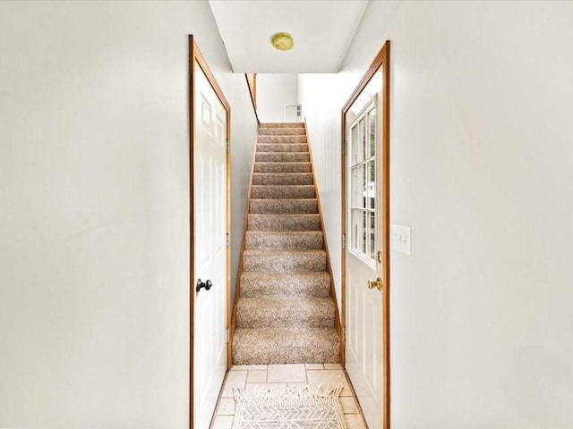 stairs with tile patterned flooring