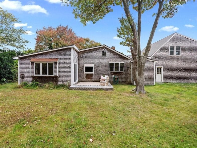 rear view of property with a yard and a patio