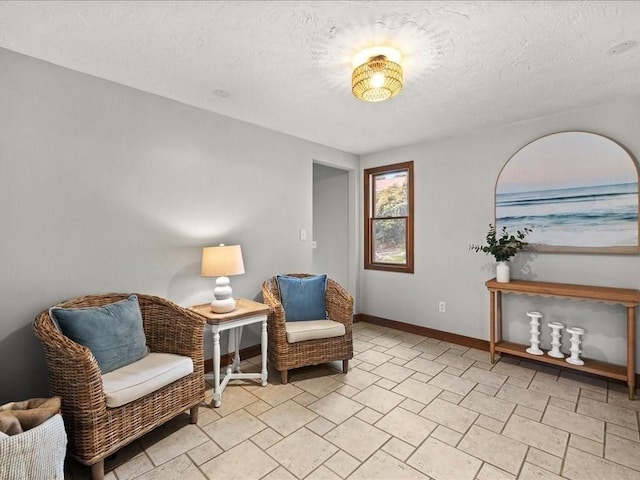 living area with a textured ceiling