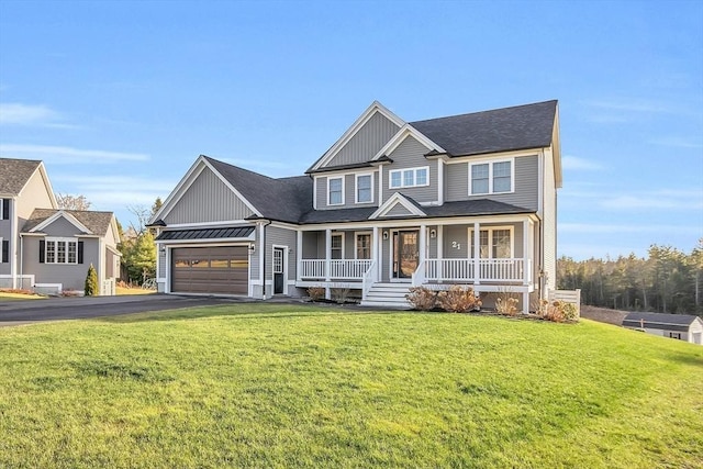 view of front of home with a porch, a garage, and a front yard