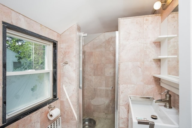 bathroom with tile walls, an enclosed shower, and vanity