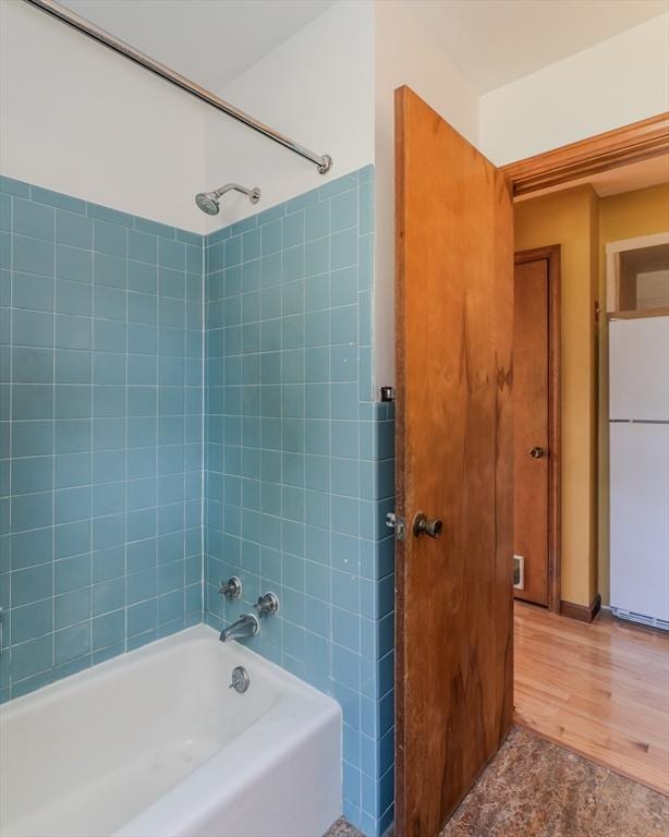 full bathroom featuring wood finished floors and tub / shower combination