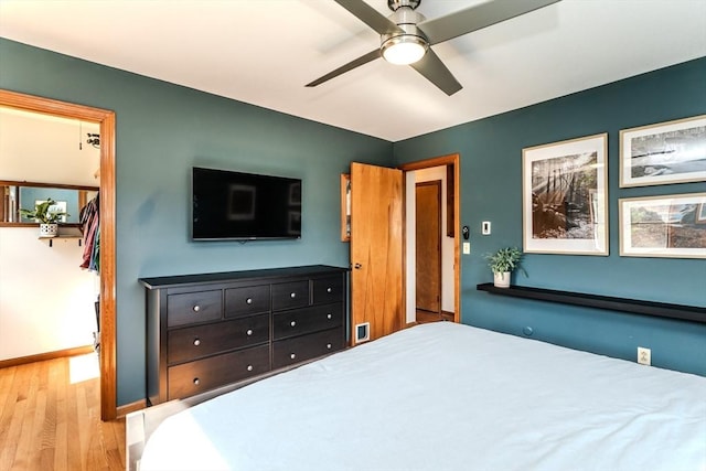 bedroom featuring baseboards, a ceiling fan, and wood finished floors
