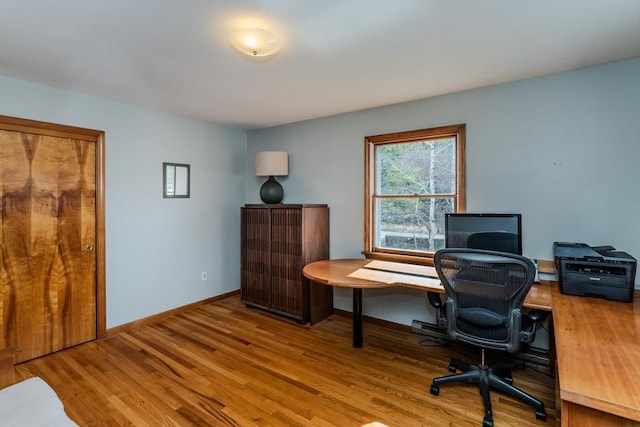 home office featuring baseboards and wood finished floors