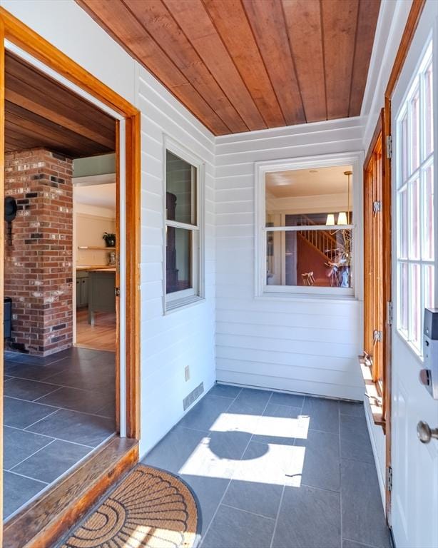 unfurnished sunroom featuring visible vents