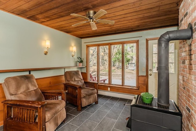 sunroom with a baseboard heating unit, french doors, and a wood stove