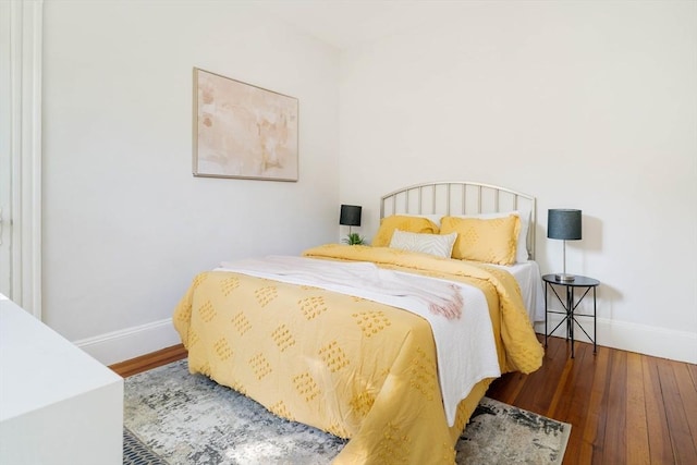 bedroom featuring baseboards and wood finished floors