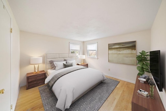 bedroom with baseboards and light wood finished floors