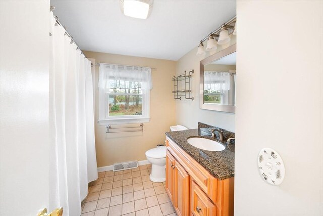 full bath featuring plenty of natural light, visible vents, tile patterned flooring, and vanity