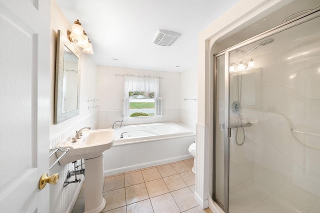 full bathroom featuring a stall shower, visible vents, toilet, tile patterned floors, and a garden tub