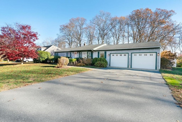 ranch-style house with a garage, aphalt driveway, and a front yard