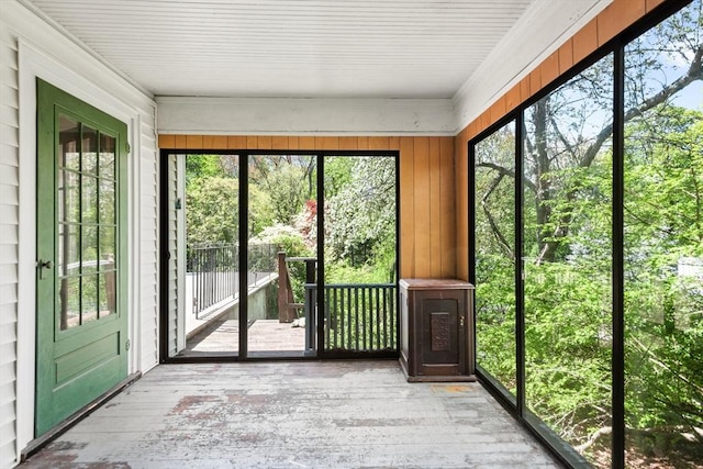 unfurnished sunroom with hardwood / wood-style floors