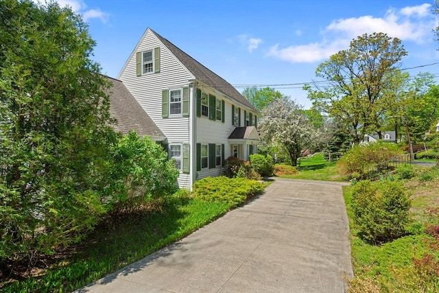 view of property exterior with roof with shingles