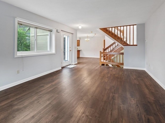 3 Loyalist Dr Unit 3, Uxbridge, MA 01569 - unfurnished living room featuring a chandelier, dark wood finished floors, stairway, and baseboards
