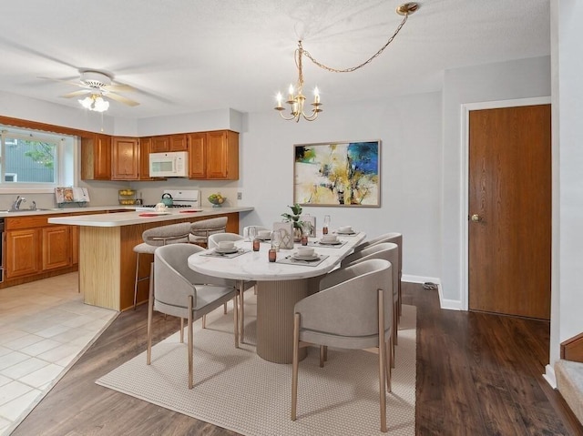 3 Loyalist Dr Unit 3, Uxbridge, MA 01569 - dining room with a chandelier, light wood-style floors, a ceiling fan, and baseboards