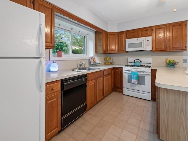 3 Loyalist Dr Unit 3, Uxbridge, MA 01569 - kitchen featuring white appliances, a sink, light countertops, and brown cabinetry