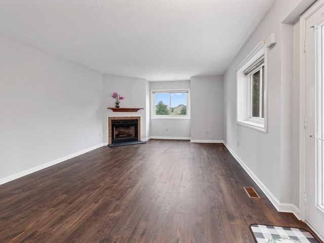 3 Loyalist Dr Unit 3, Uxbridge, MA 01569 - unfurnished living room featuring dark wood finished floors, a tiled fireplace, and baseboards