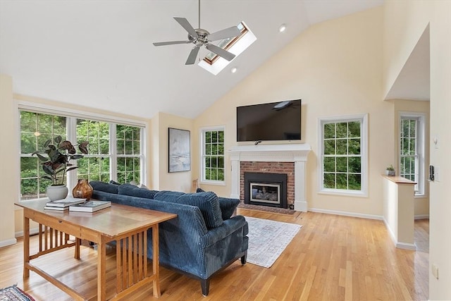 31 Fort Pond Hill Rd, Littleton, MA 01460 - living area featuring high vaulted ceiling, ceiling fan, a skylight, a fireplace, and light wood finished floors