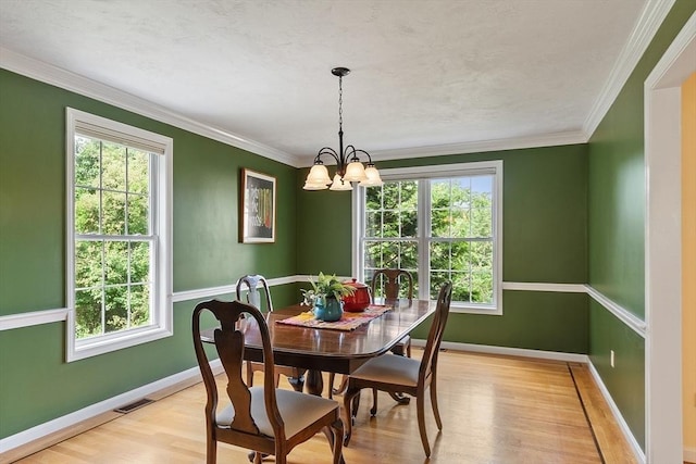 31 Fort Pond Hill Rd, Littleton, MA 01460 - dining space with healthy amount of natural light, light wood-style flooring, a chandelier, and crown molding