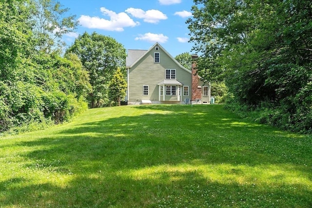 31 Fort Pond Hill Rd, Littleton, MA 01460 - rear view of property featuring a chimney and a yard