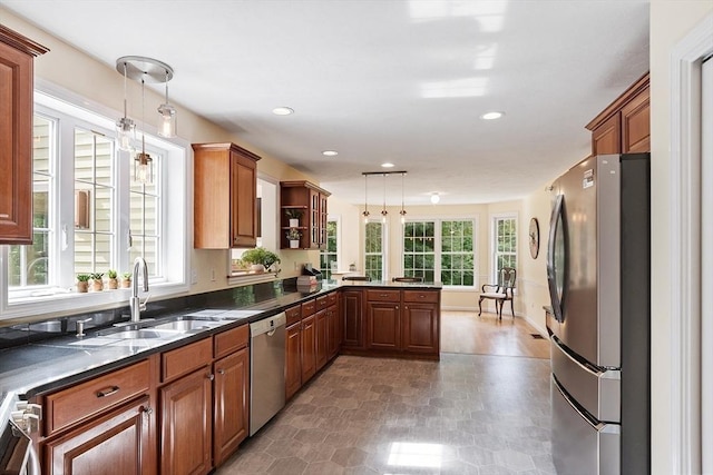 31 Fort Pond Hill Rd, Littleton, MA 01460 - kitchen with stainless steel appliances, a peninsula, brown cabinets, hanging light fixtures, and recessed lighting