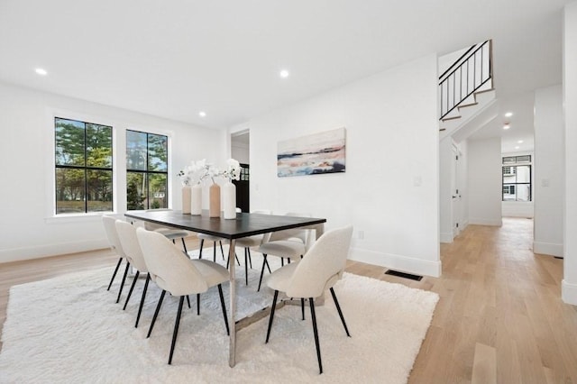 dining area featuring baseboards, plenty of natural light, light wood-style flooring, and visible vents